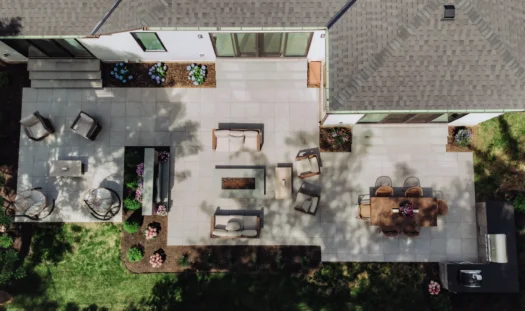 Aerial view of an 800-square-foot GeoCeramica porcelain paver patio with dining, lounge, fire pit, TV and grilling areas in Upper Arlington, Ohio.