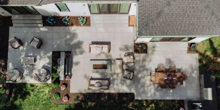 Aerial view of an 800-square-foot GeoCeramica porcelain paver patio with dining, lounge, fire pit, TV and grilling areas in Upper Arlington, Ohio.
