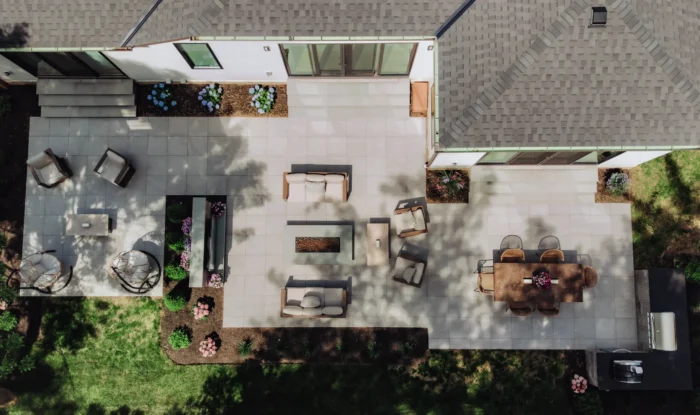 Aerial view of an 800-square-foot GeoCeramica porcelain paver patio with dining, lounge, fire pit, TV and grilling areas in Upper Arlington, Ohio.