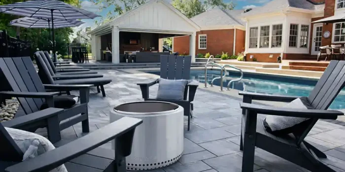 Unilock Beacon Hill paver pool deck with pavilion, outdoor fireplace, TV wall, and landscaped backyard in Central Ohio