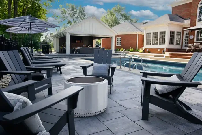 Unilock Beacon Hill paver pool deck with pavilion, outdoor fireplace, TV wall, and landscaped backyard in Central Ohio