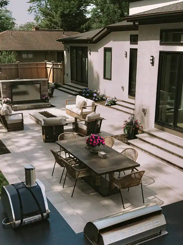 Outdoor Kitchen and Porcelain Paver Patio – Upper Arlington Upper Arlington outdoor living space with a GeoCeramica porcelain patio, dining area and custom grill island with a steel gray leathered granite countertop.