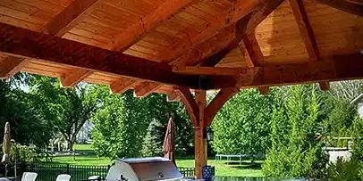 Cedar pavilion with outdoor kitchen and stainless steel grill with granite countertops in Central Ohio backyard