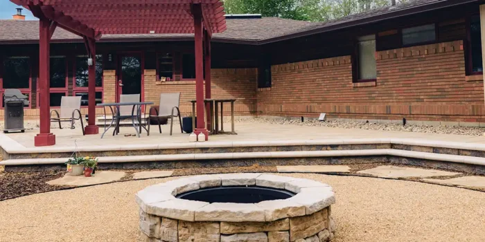 Completed backyard transformation featuring a large natural flagstone patio and integrated landscaping.