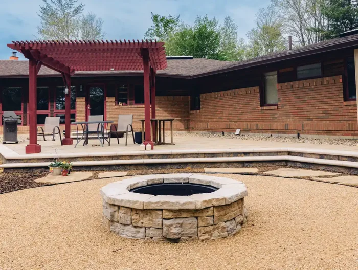 Completed backyard transformation featuring a large natural flagstone patio and integrated landscaping.