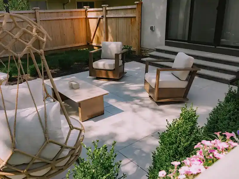 Porcelain Paver Patio, Custom Steps and Landscaping GeoCeramica porcelain paver patio with custom Unilock steps, lounge seating and fresh landscaping in an Upper Arlington backyard.