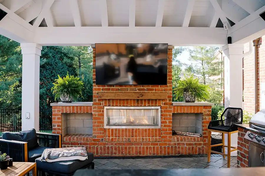 Custom outdoor fire pit installation using Unilock dimensional block in Central Ohio backyard patio