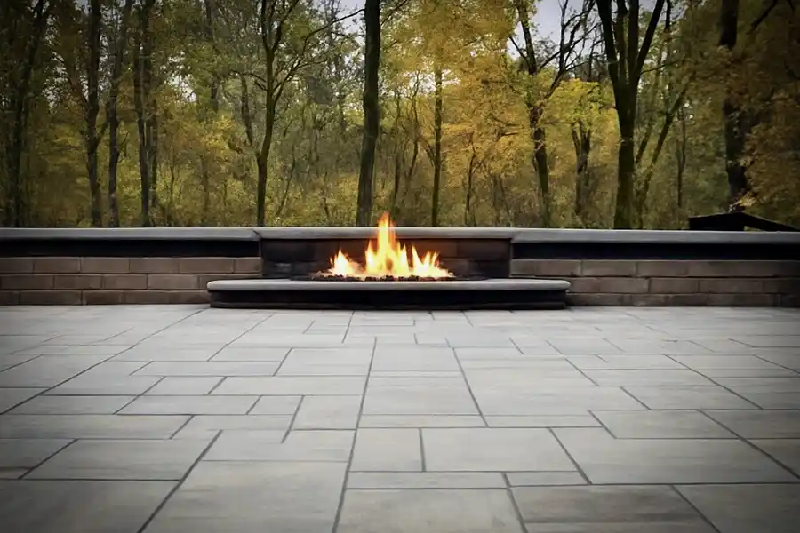 Outdoor living patio with custom fire pit constructed with Unilock dimensional block