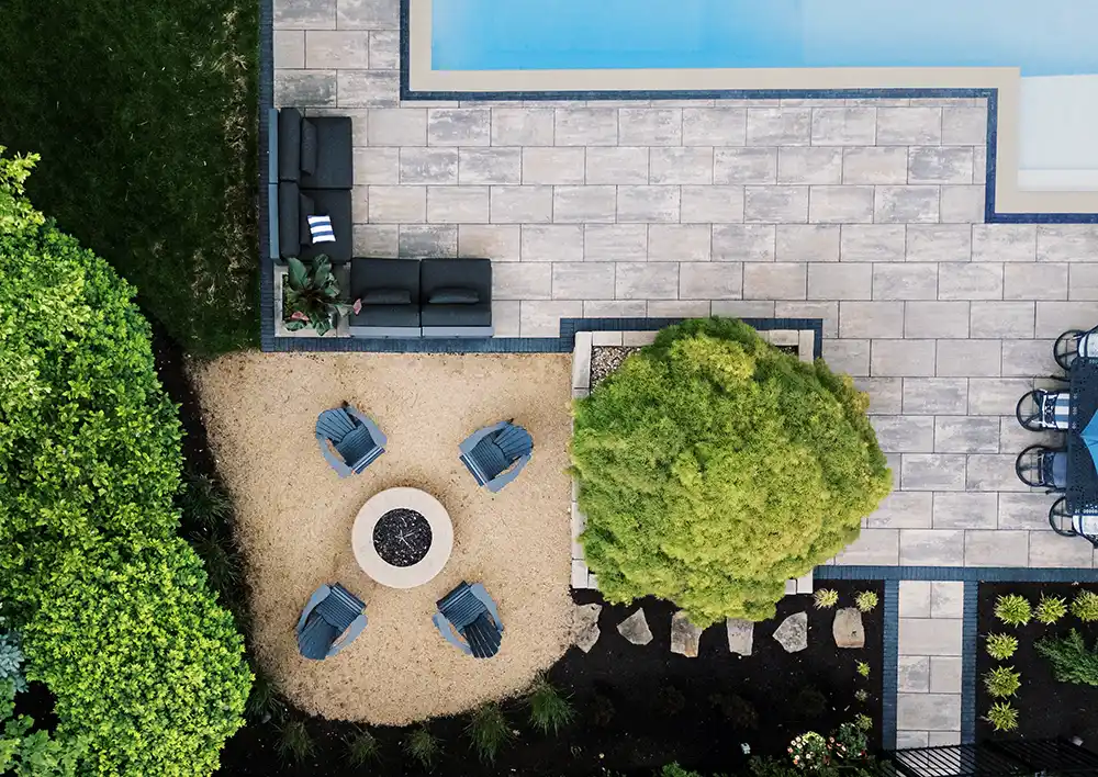 Aerial view of a custom paver pool deck and fire pit patio in a Central Ohio backyard.
